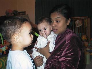 My Sister-in-Law Yufrita holds Fabian as Adam looks on